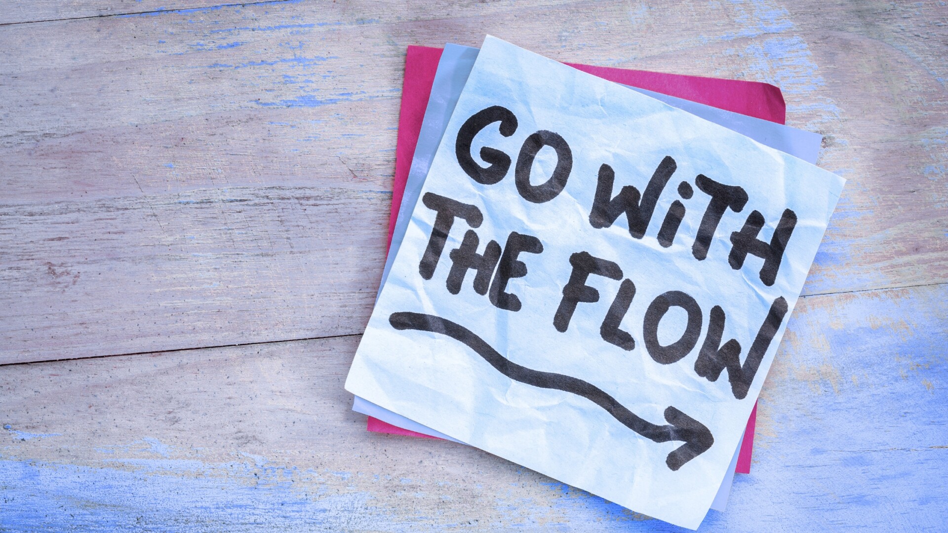 Post it note with “Go with the flow” written on it, representing a theme of the year vision board