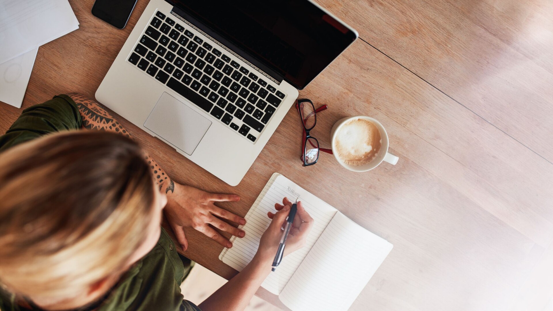 Woman checking items off a to do list while organizing finances
